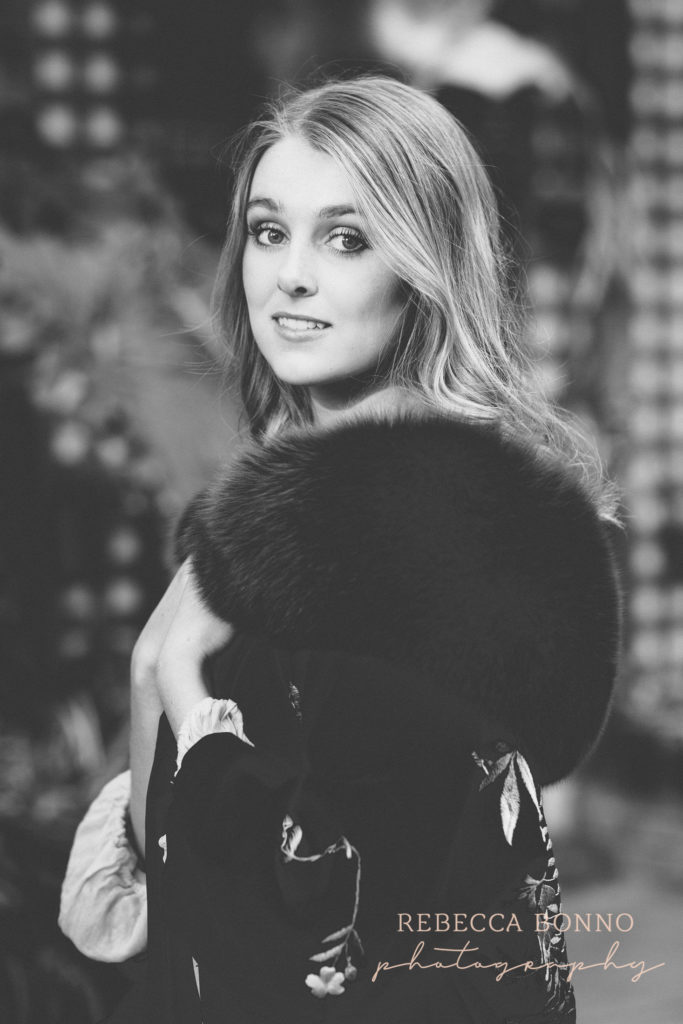 beautiful lovely balck and white photo of  senior session with red fur jacket  and rebecca bonno Photography 